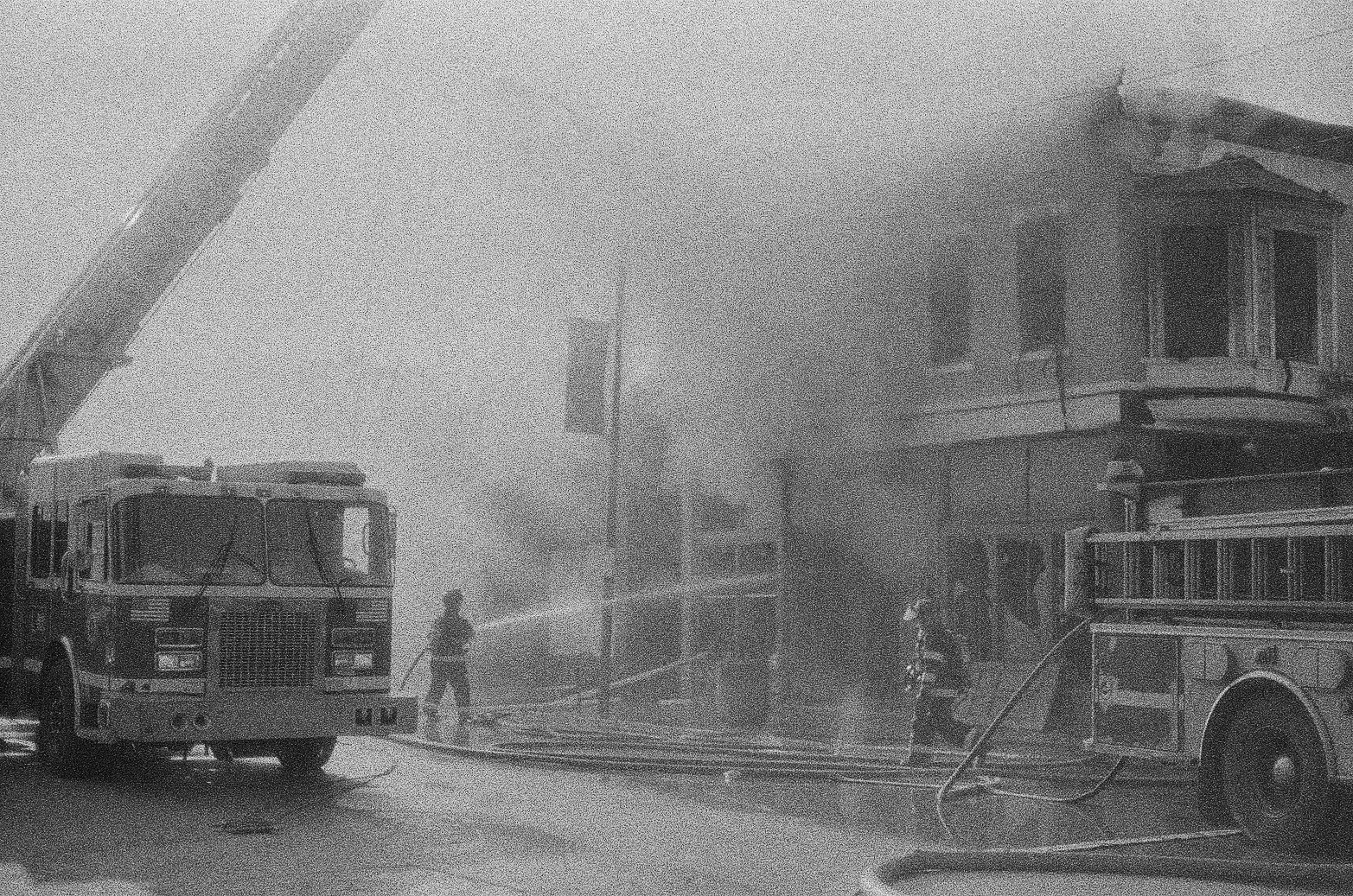 Black and white 35mm photo of the Cleveland Fire Department putting out a fire on Lorain Ave
