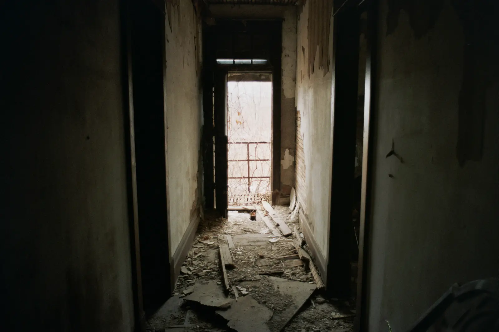 35mm photo of a creepy hallway in an abandoned building